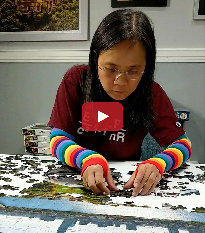 A photo of MIT alum Tammy McLeod piecing together a puzzle on a table