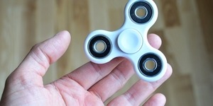 A person holding a fidget spinner