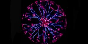A circle glows pink at the center. Purple lines radiate outward in wavy lines that lead to pink ends, which together form a larger circle.