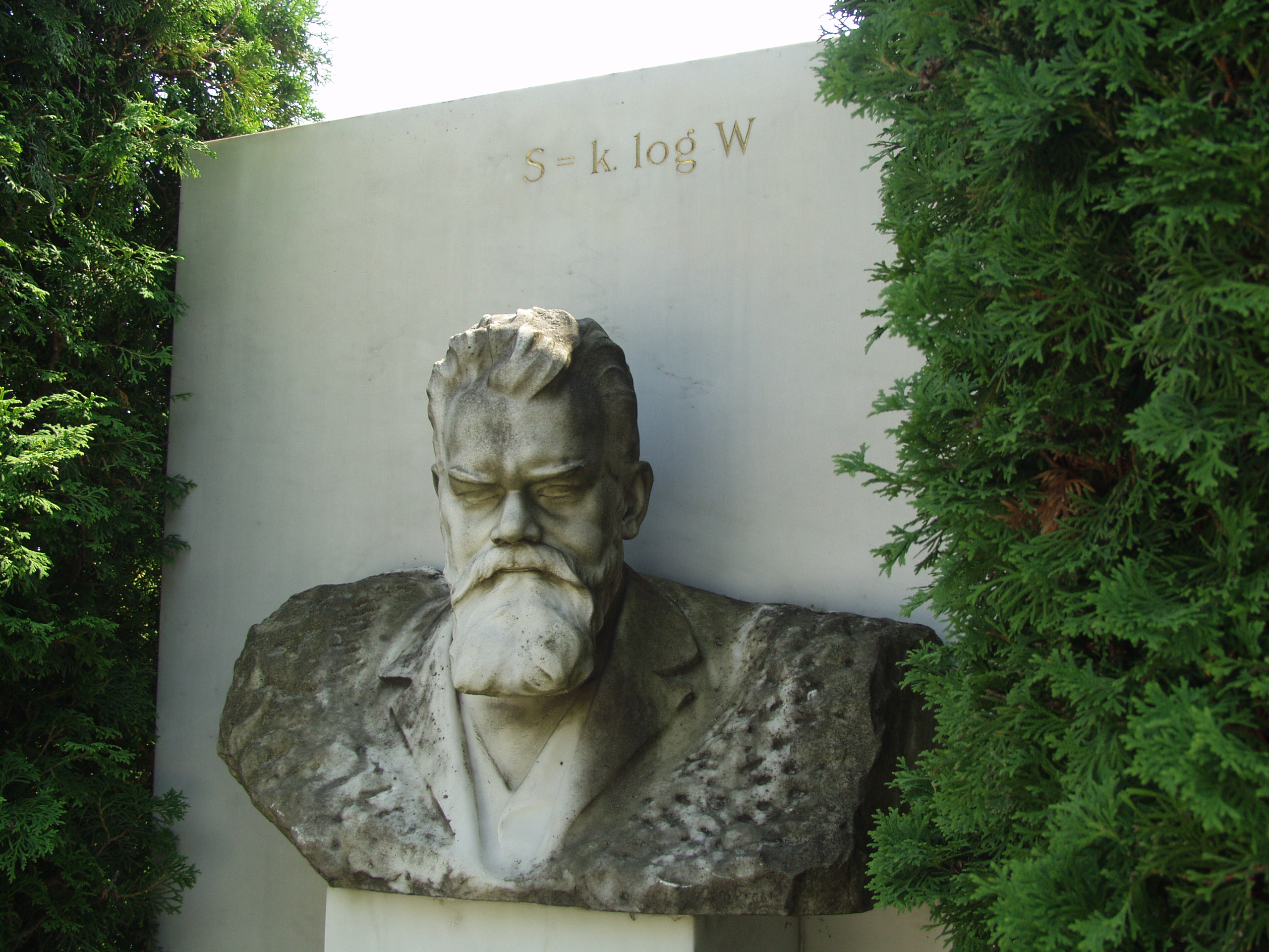 Vienna, Austria. Boltzmann's Tomb in the Zentralfriedhof (Central Cemetary). The Tomb is in Gruppe 14 C Grab No 1 (group 14 grave number 1). Photos by Tom Schneider or of him by Gerd Muller. 2002 July 14. This image: bust of Boltzmann. <a href = 