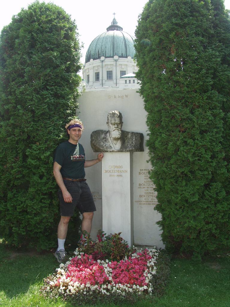 Vienna, Austria. Boltzmann's Tomb in the Zentralfriedhof (Central Cemetary). The Tomb is in Gruppe 14 C Grab No 1 (group 14 grave number 1). Photos by Tom Schneider or of him by Gerd Muller. 2002 July 14. This image: Tom Schneider with bust of Boltzmann. <a href = 
