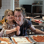 A photo of Rhiannon Menn and her daughter in a kitchen making lasagnas