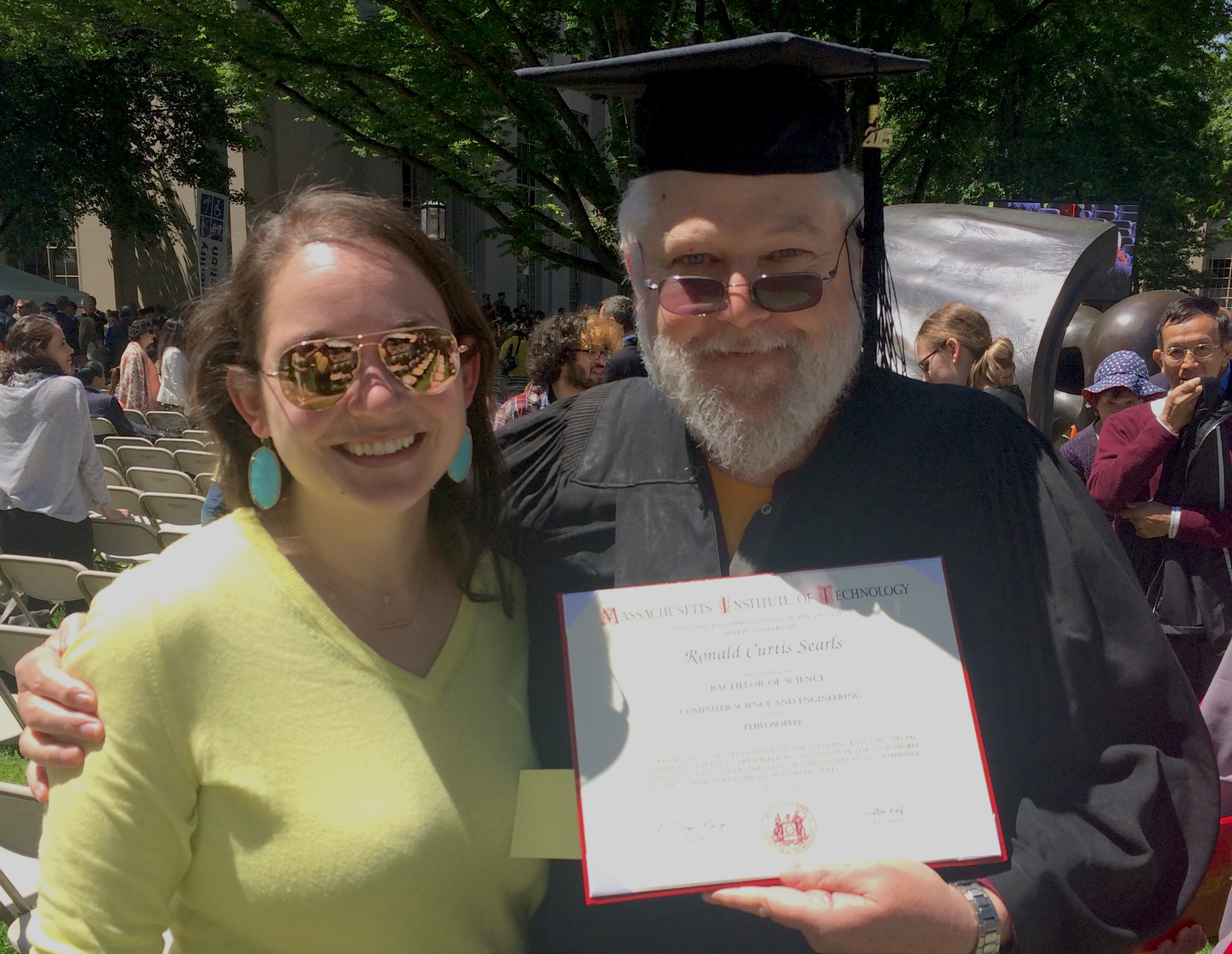 Man graduating from MIT with his daugher