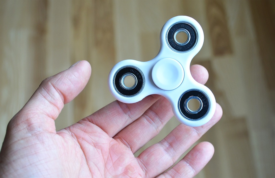 A person holding a fidget spinner