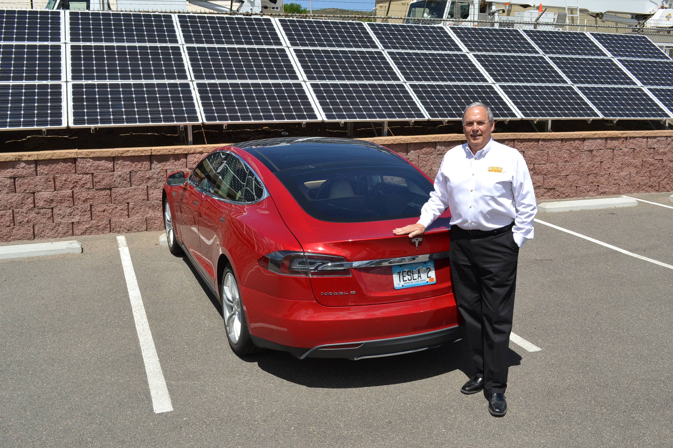 Jim Smith '69 with his electric car and solar panels.