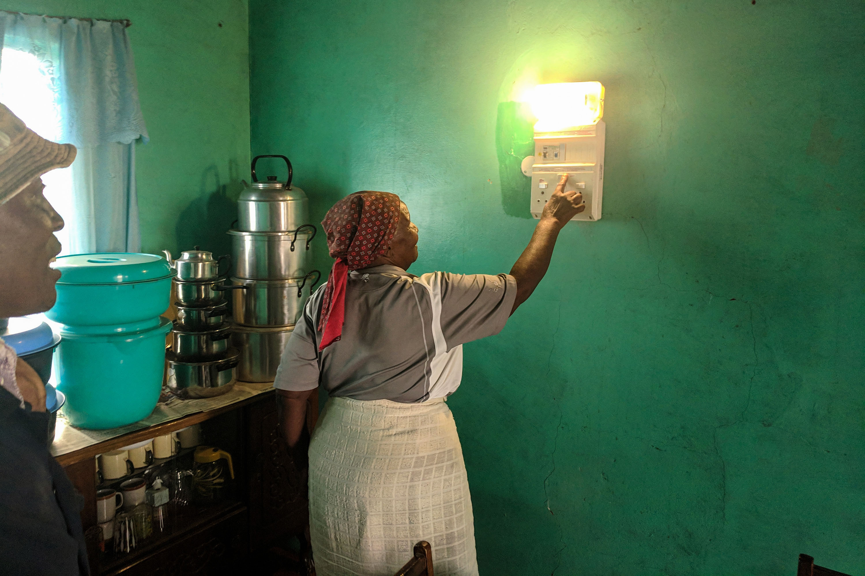 Woman presses wall device that lights up