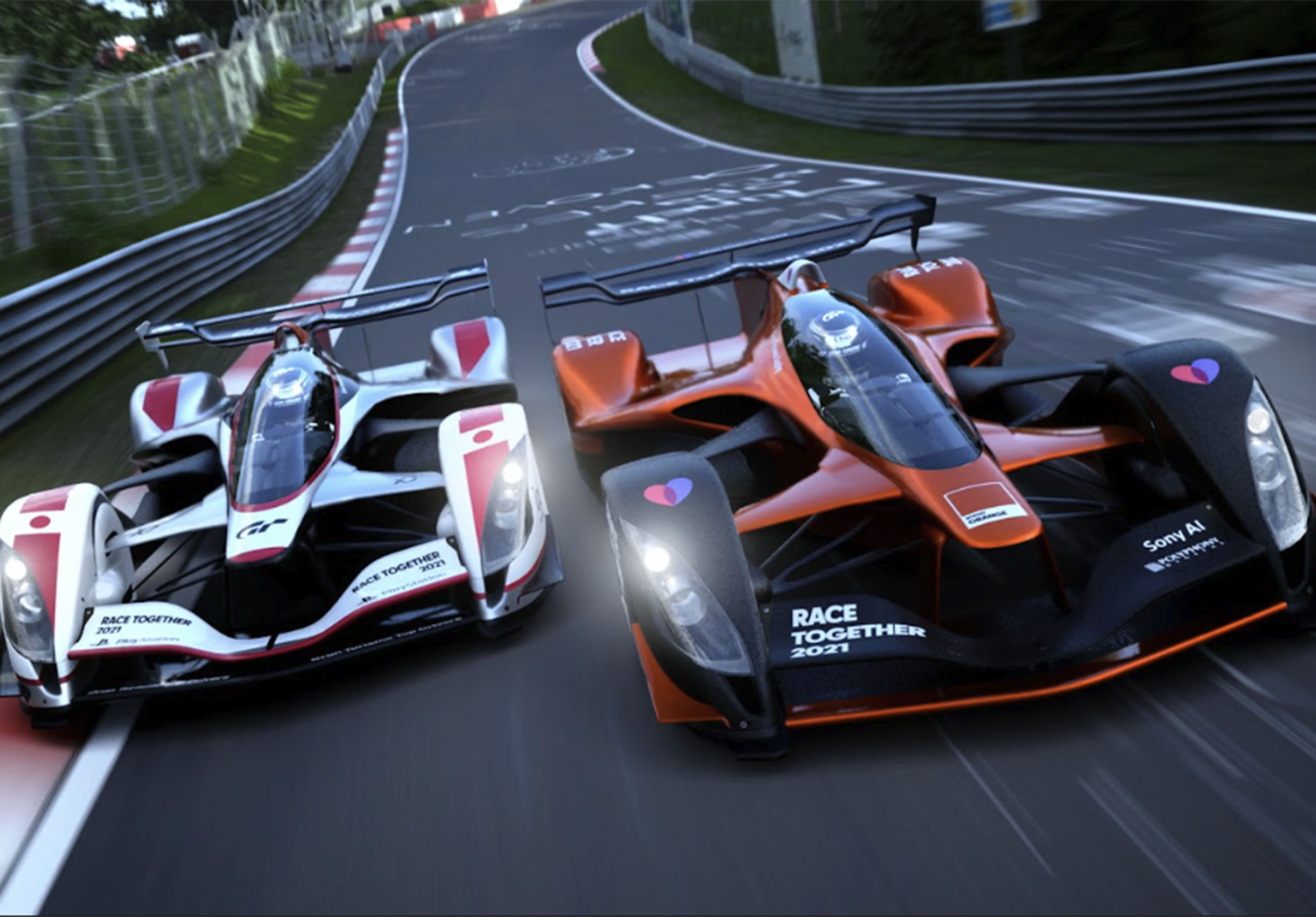 Game image of two racecars side by side. They are seen from the front with track behind them.