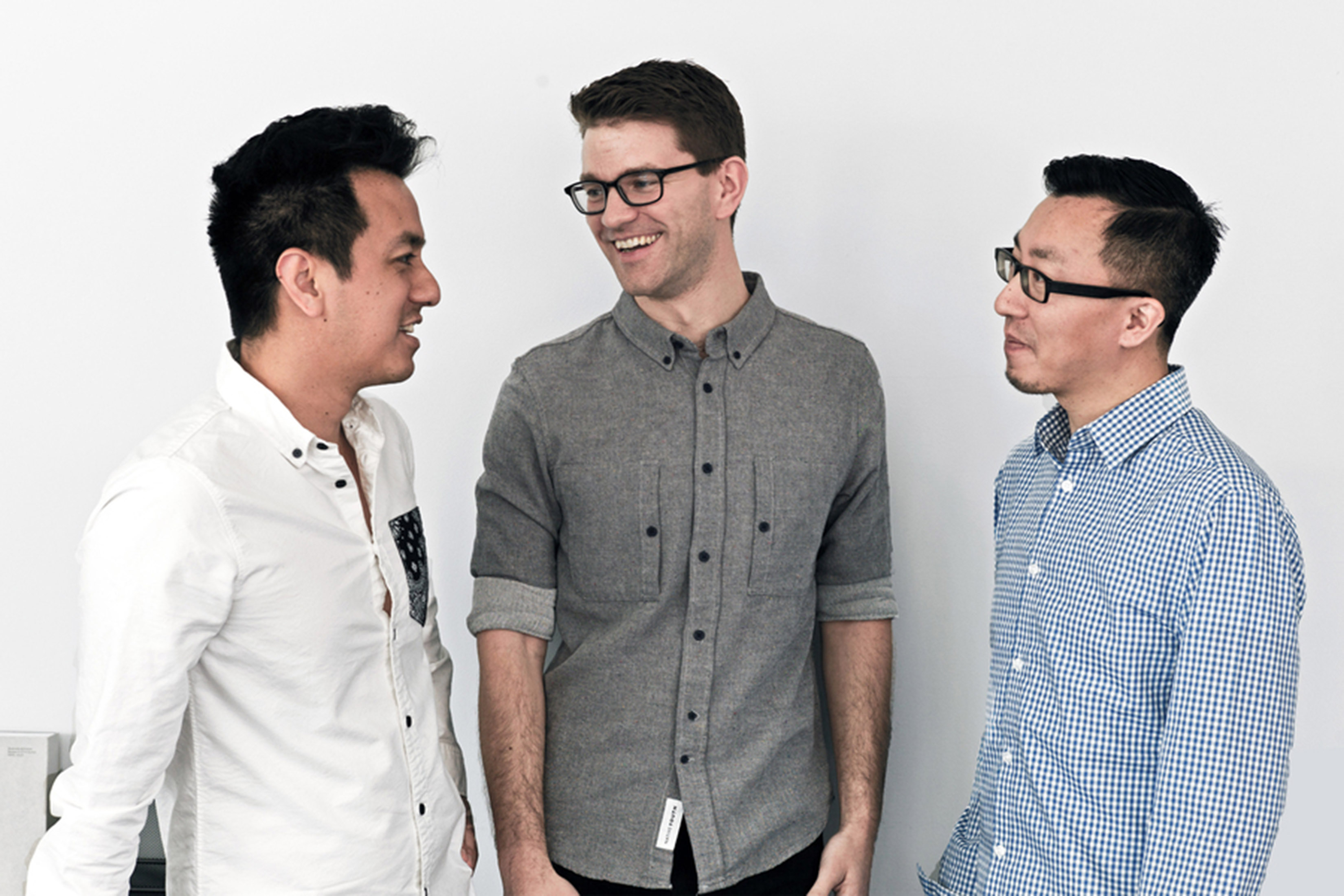Moe Amaya, Alex Dixon, and Robert Yuen (L-R) appear in casual conversation. Background is a white wall.