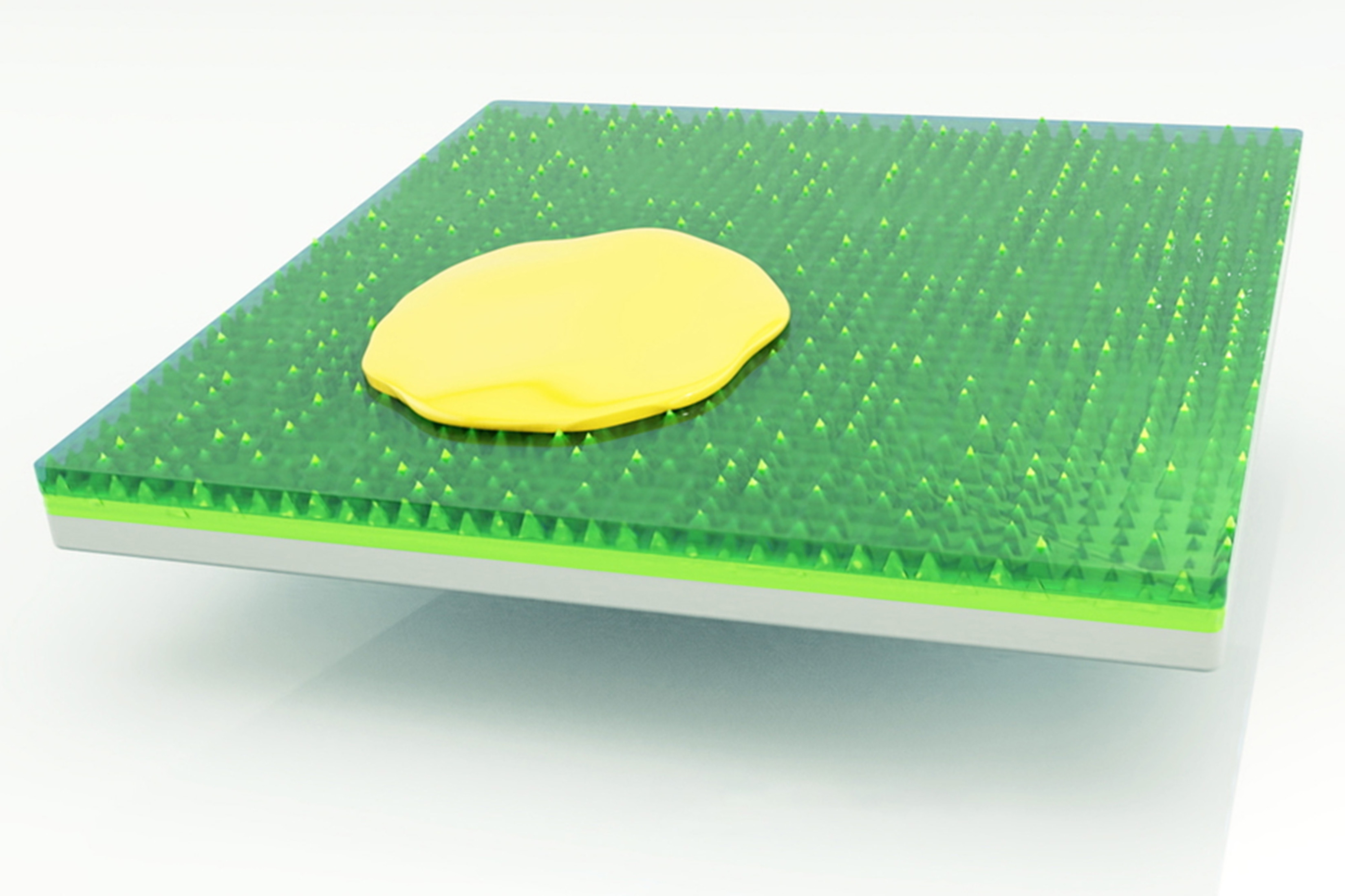 Illustration shows a yellow blob on a square green surface. The green material looks rubbery and appears to have spikes embedded in it.