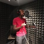 Photo of Kelvin Frazier recording in studio