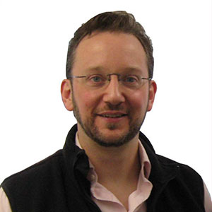 Matt Duplessie headshot, white man in vest 