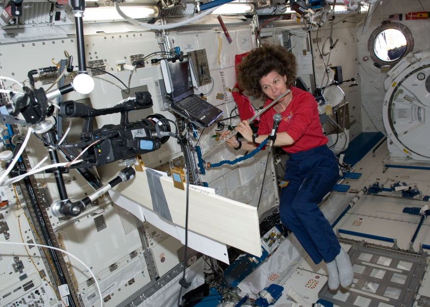 Astronaut Cady Coleman plays her flute on the ISS