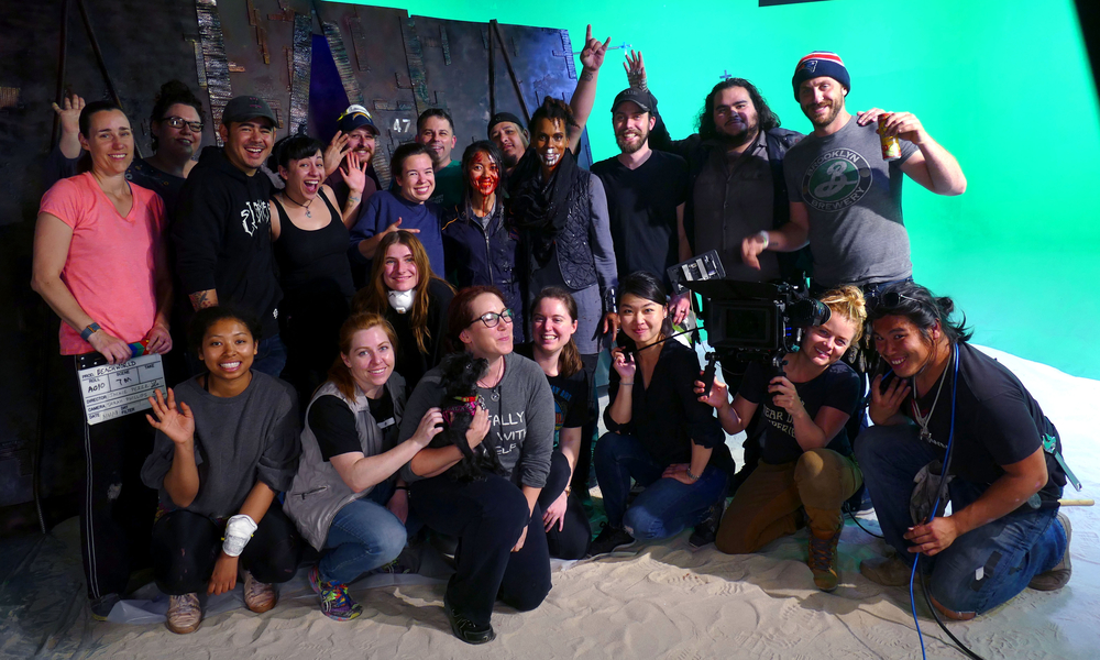 Group shot of the cast and crew of Beachworld, on set
