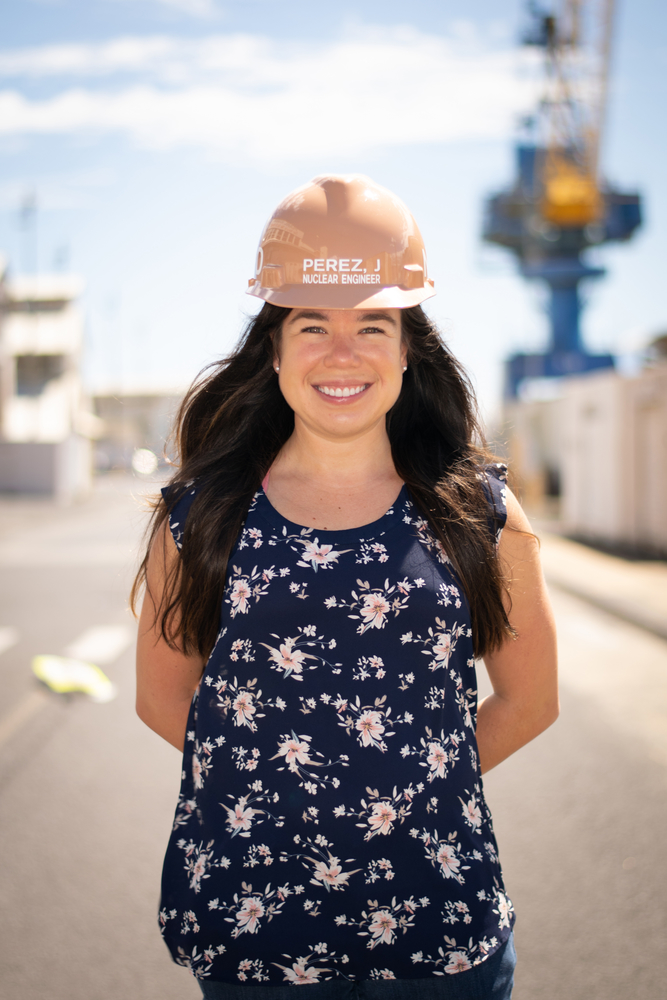 Perez wearing hardhat at shipyard with a crane in the background