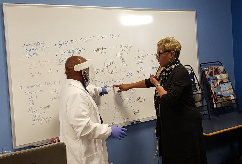 Osie Combs and Nebraska DHHS CEO Danette Smith at a white board
