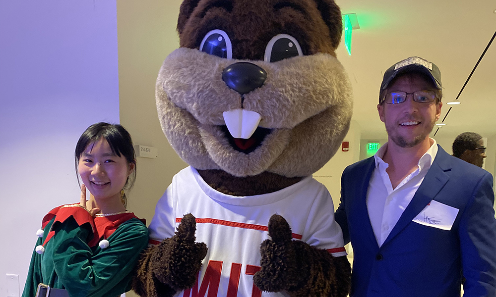 Jase Wilson and Xueying Wilson standing with Tim the Beaver between them