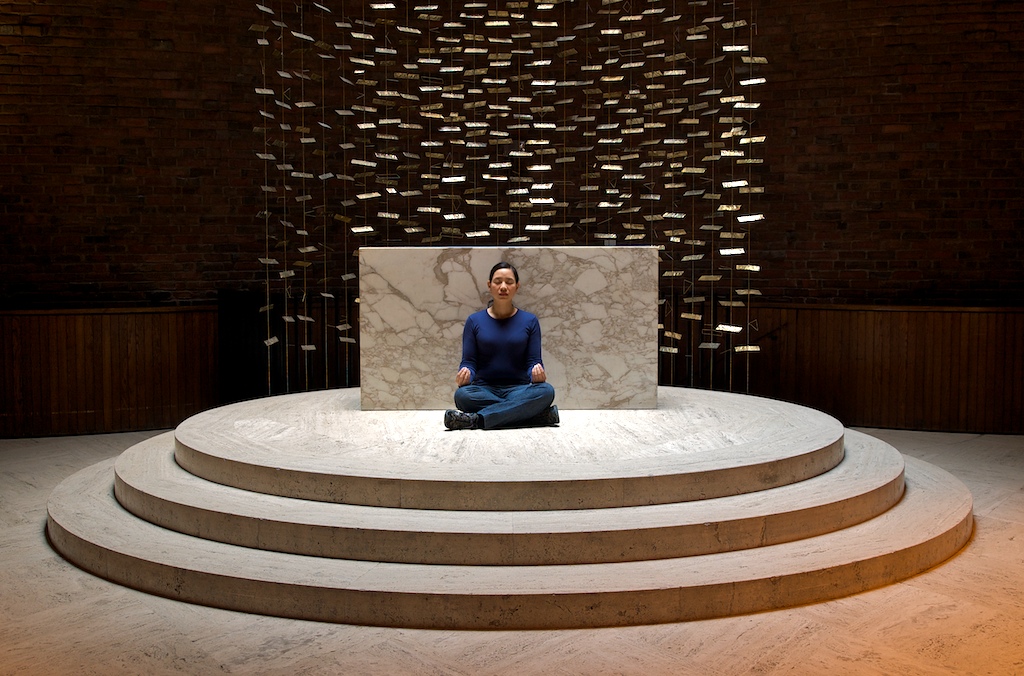 A woman sits in the Eero Saarinen chapel on campus. Photo: j9lyn, Flickr