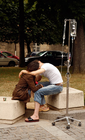 A couple taking a break outside the Hospital St. Louis, Paris. (© Owen Franken)
