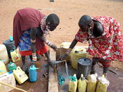 Maasai women fill water jugs, which donkeys will carry to their village, thanks to Lemayian's help.