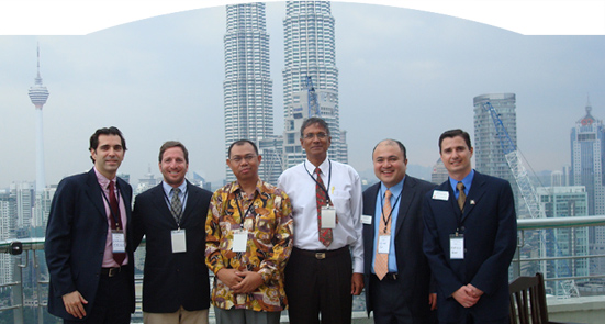 G-LAB in Malaysia : Sloan Fellows, from left, Camilo Syllos MBA '09, Alberto Gassmann MBA '09, Victor Yee MBA '09, and Marcelo Kuhn SM '09 in Kuala Lumpur, Malaysia, with two members of their client team.