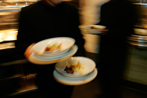 Waiters leaving the kitchen of Daniel Boulud's great French restaurant in New York, Daniel (© Owen Franken).