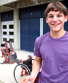Tribbett standing near the automated wheelchairs teams designed for U.S. Paralympic athlete Kerri Morgan to simulate a defensive wheelchair rugby player on the attack. Tribbett loves acting and performs in campus theater productions. He also has a passion for teaching. He works as a private math and physics tutor for local college students and plans to take his math and science skills to the Blackfoot Sioux reservation in Montana this summer to teach kids there and involve them in projects like water purification. Tribbett himself is half Sioux and hopes to show kids life options beyond the reservation.