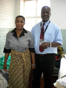 Dr. Nyengo Mkandawire, the only Malawian-born orthopedic surgeon operating in Malawi today, with a patient of his who had been treated for four months by a traditional healer for a herniated disc in her low back. She was unable to walk when she came to Queens Hospital. Mkandawire performed a lumbar discectomy surgery on her, and just before this picture was taken, they were dancing together!