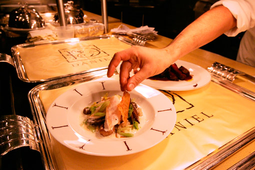 Plating a dish in the kitchen of the French restaurant Daniel, a top eatery in New York