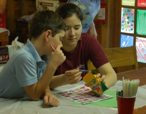Camp Kesem founder Carol Huang enjoys arts and crafts with a camper.