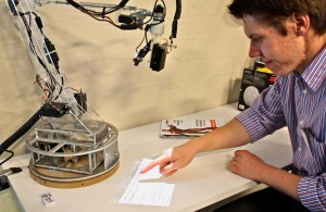 Grad student Natan Linder directs the LuminAR lamp.