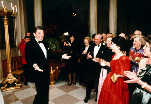 Ronald Reagan looks dashing to of a group of admiring women, just before blowing out his 70 birthday candles in 1981. His birthday was February 6 (© Owen Franken/Sygma/Corbis).