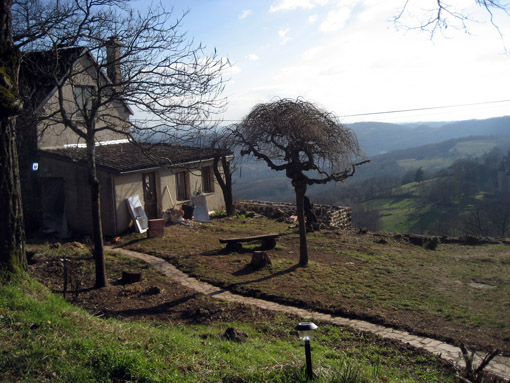 The front of one of the two farmhouses, showing a fraction of the students' work. The slope on the left side was overgrown with brambles, bushes, and small trees before they arrived, and the path was not visible.