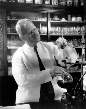 Professor Samuel Cate Prescott at work on the perfect cup of java. Notice the coffee cans on the top of the cabinet behind him. The folder in front of him reads “The New  Science of Automatically Controlled Coffee Making.” Photo: MIT Museum.