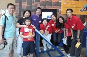 The Lins, left, helped two Chinese school teams come to EurekaFest at MIT.