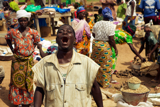 Man in a public market in Benin, West Africa (© Owen Franken).