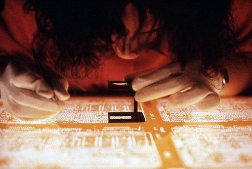 Technician making etching of integrated circuits, Dresden, East Germany, 1990