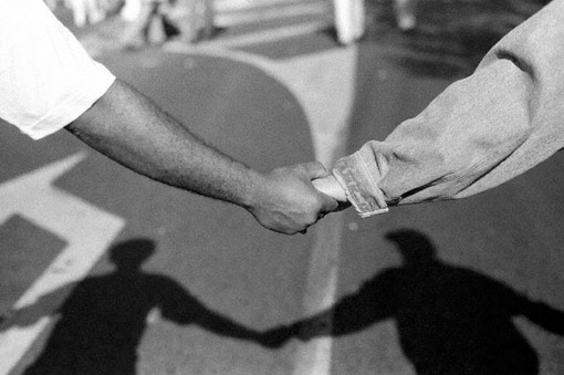 Black and white demonstrators hold hands, Paris, 1995