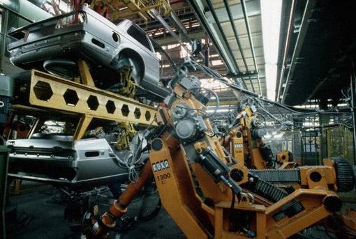 Robot Working on Car at the BMW Factory in Munich, West Germany, September 1984 (© Owen Franken/CORBIS).