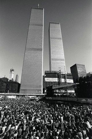 A crowd protests nuclear energy on a plaza in the shadow of the World Trade Center Towers, New York City, ca. 1966–1973 (© Owen Franken).