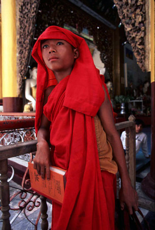A schoolboy in red at the Shwedagon Pagoda, Burma (© Owen Franken).
