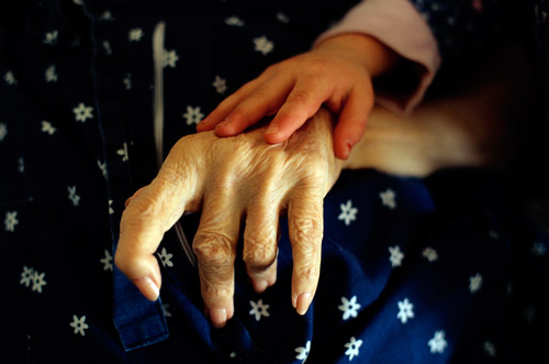 Owen's daughter, Manui Franken, puts her hand on the hand of Phoebe Franken, her grandmother (© Owen Franken/CORBIS).