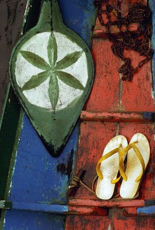 Thongs and oar on colorful canoe, Amazon River, Brazil, April 1986 (© Owen Franken/CORBIS).