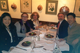 Shawn (far left) and her older brother (right) enjoying dinner with Becky Donnellan ’72 (back left) and her family.