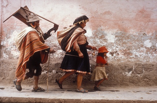 Blind harpist being led by his wife and daughter through the streets of Cusco, Peru. Photo: Owen Franken.