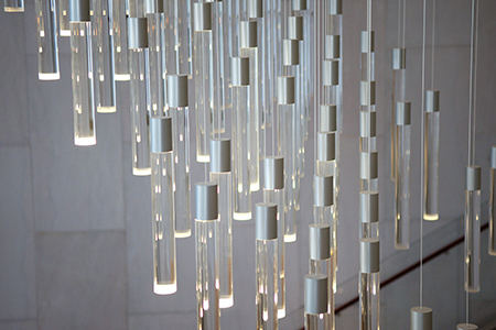 Close-up view of the chandelier's pendants, which act as data points.