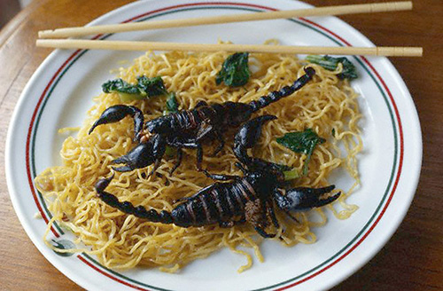 A Thai dish of fried black scorpions and noodles in Bangkok (© Owen Franken)