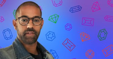 Vikas Sodhani headshot silhouetted against a blue background with gem shapes.