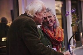 Elderly couple smiling and talking 