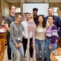 A team poses with its pencil and foam "skyscraper" during MIT UPOP's weeklong workshop