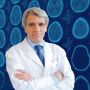 Image of Dr. Stephen Hauser in front of a graphic grid MRI brain scans with blue coloring